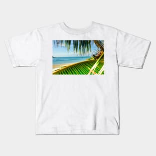 Tropical beach scene with palm fronds. Kids T-Shirt